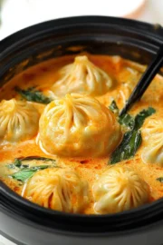 Soup Dumplings in Thai Red Curry Sauce - One Happy Bite